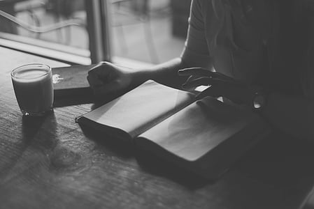 grayscale photo of person opening book thumbnail