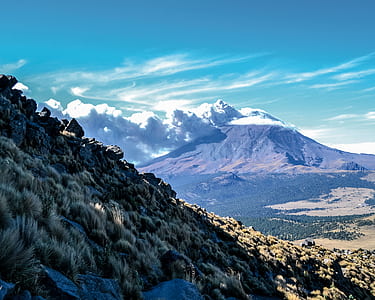 Brown Mountain Under White Clouds and Blue Sky thumbnail