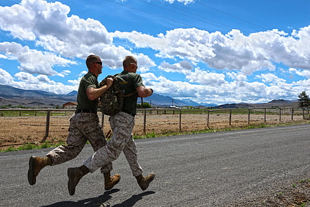 two man running on asphalt road under sunny sky thumbnail