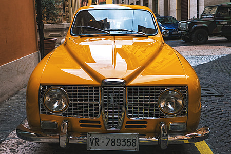 Classic old yellow Saab car thumbnail