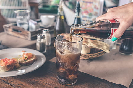 person pouring cola on highball glass thumbnail