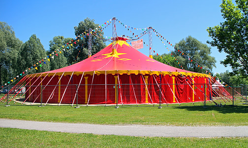 yellow and red canopy tent under blue sky thumbnail