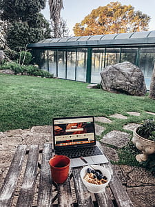 Turned-on Macbook Pro on Brown Table thumbnail