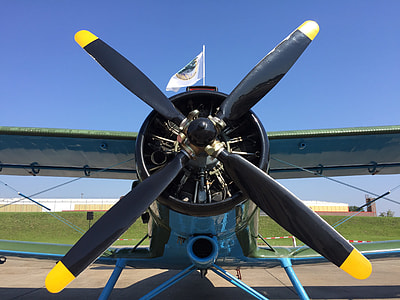 blue and black monoplane near green grass thumbnail