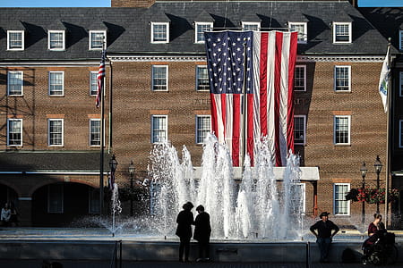 Old brick administration building with large American flag hanging in Alexandria, Virginia. thumbnail