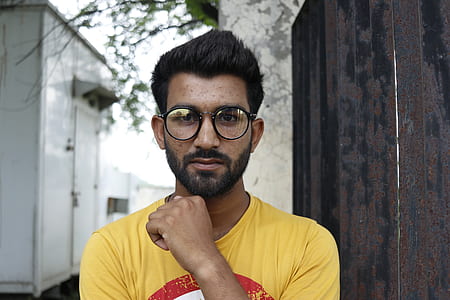 man wearing black eyeglasses and yellow shirt thumbnail