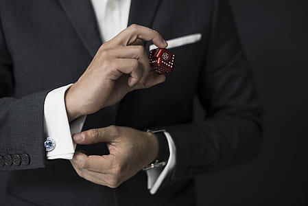 person holding dice and dress shirt thumbnail