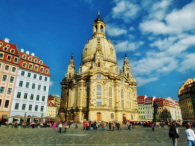 group of people in front of yellow concrete building during daytime thumbnail