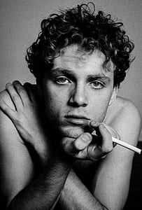 man holding cigarette photo thumbnail