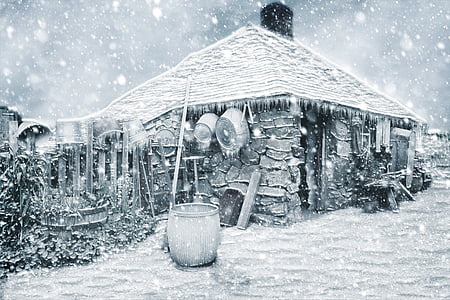 drum beside snow covered house thumbnail
