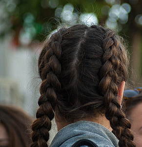 woman with braided hair wearing gray collared shirt thumbnail