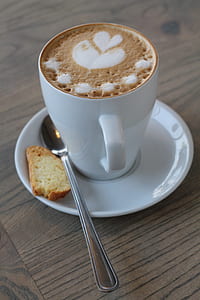 coffee latte on cup with piece of bread thumbnail