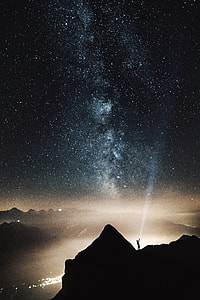 person holding flashlight on mountain thumbnail