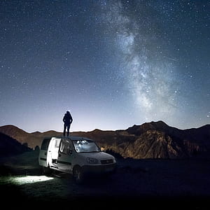 silhouette of person standing on white van thumbnail