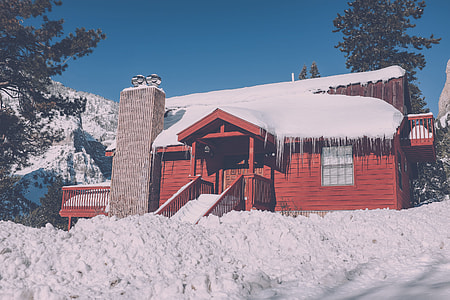 red 2-storey house surrounded by snow thumbnail