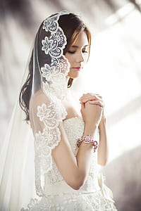 tilt shift lens photography of woman wearing white wedding gown thumbnail