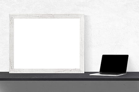 MacBook Pro beside photo frame thumbnail