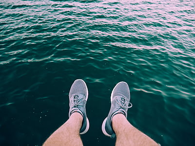 person wearing gray low-top shoes thumbnail