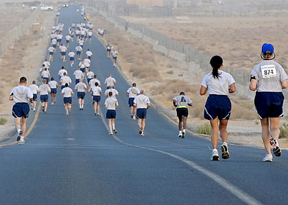 people walking across a road between a desert thumbnail