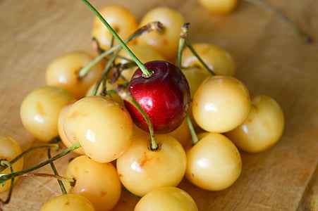 close-up photography of red cherry on beige cherries thumbnail