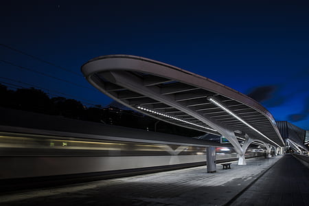 gray concrete subway station under blue sky thumbnail