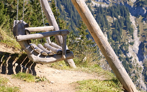wooden swing bench placed on hill thumbnail