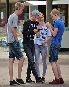 three men standing next to girl thumbnail