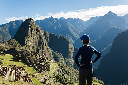 girl standing on Mossu Piccu, Peru under blue sky thumbnail