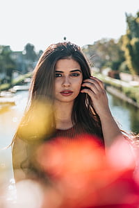 woman standing against body of water thumbnail