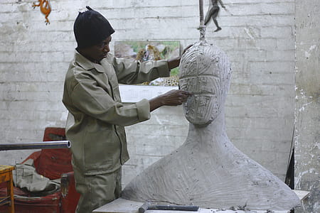 man carving a head bust thumbnail