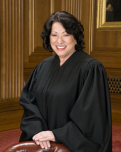 woman wearing black long-sleeved dress smiling thumbnail