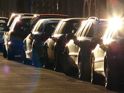 assorted cars in line near gray concrete wall during daytime thumbnail