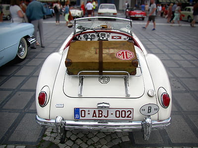 white convertible car on parking lot at daytime thumbnail