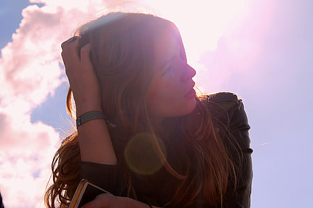 low angle photo of woman in black leather top under blue sky thumbnail