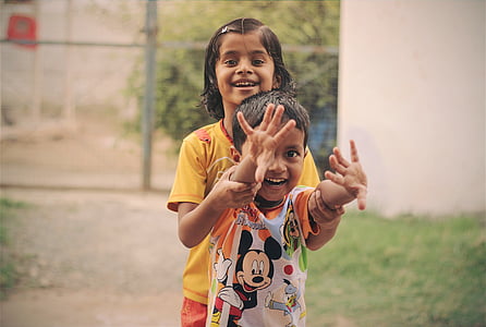 girl holding toddler's hand thumbnail