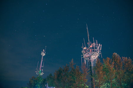 low angle photo of metal towers under night sky thumbnail