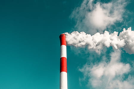 red and white painted concrete chimney emitting smoke at daytime thumbnail