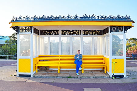 woman sitting on yellow bench thumbnail