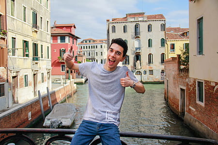 man sitting on bridge rail thumbnail