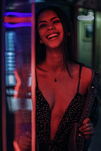 woman wearing plunging neckline dress behind glass door thumbnail