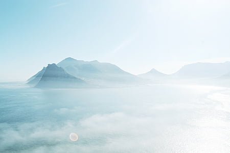 photo of mountain under white sky at daytime thumbnail
