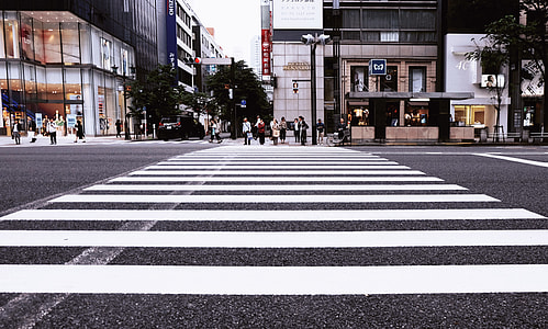 people waiting to cross on the pedestrian lane during daytime thumbnail