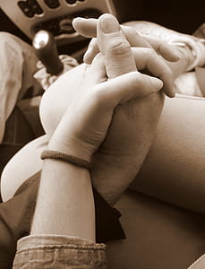 sepia photography of two people holding hands thumbnail
