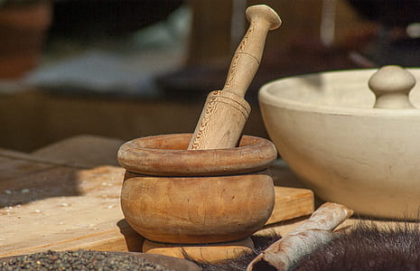 brown wooden mortar and pestle on brown wooden table thumbnail