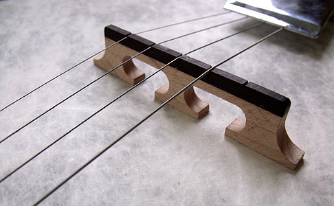 shallow focus photography of guitar strings thumbnail