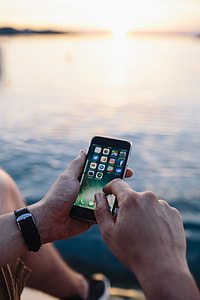 Mobile phone in man's hands near the sea thumbnail