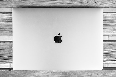 silver MacBook on gray wooden surface thumbnail