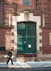 man passing near green door thumbnail