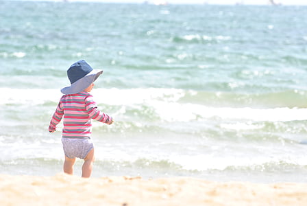 baby walking gray, red, and pink striped long-sleeved shirt near body of water thumbnail
