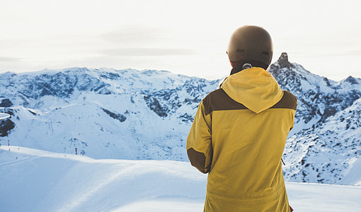 man over viewing snowy mountain during daytime thumbnail